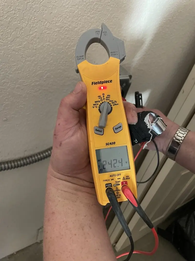 Voltage testing with clamp meter during Whole House Surge Protector in East Riverdale